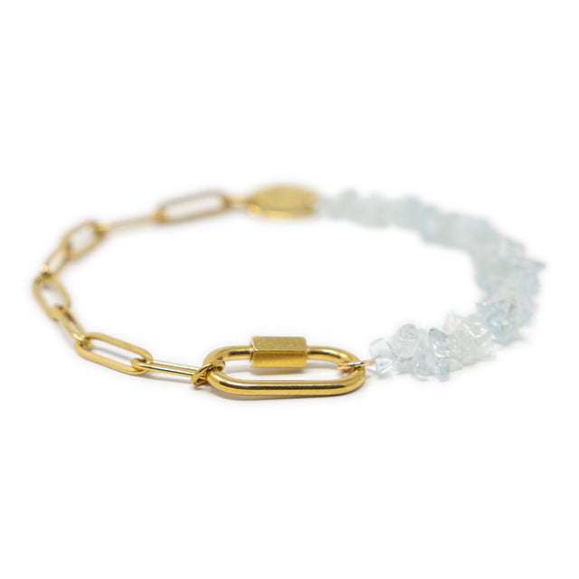 Charm bracelet with gold chain and aquamarine beaded section on a white background