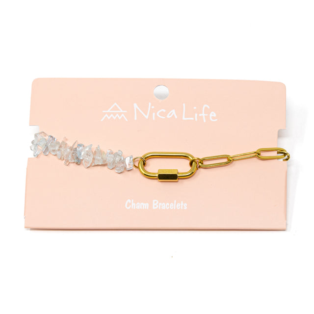Charm bracelet with aquamarine crystal and gold chain design on a Nica Life branded card