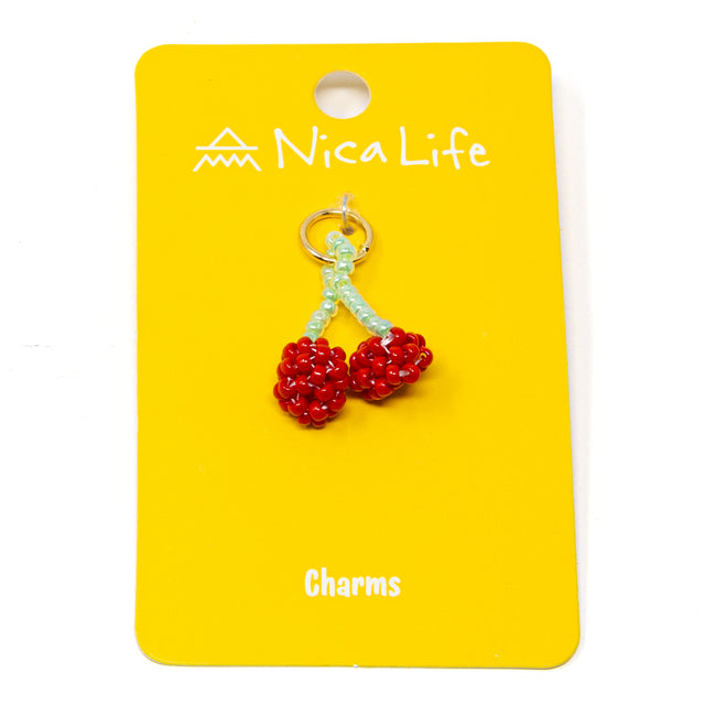 Beaded cherry charm on a yellow card with 'Nica Life' branding