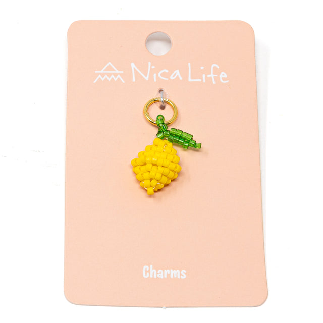 Hand beaded lemon charm on pink Nica Life branding card