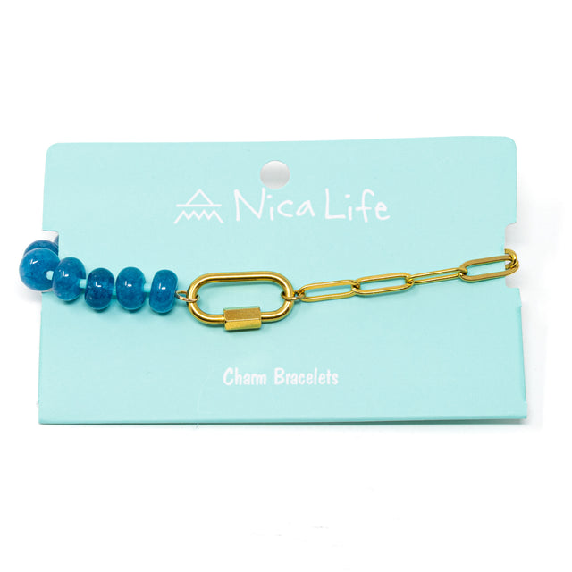 Bracelet with blue beads and gold chain and a gold carabiner for charms on a teal Nica Life branded card