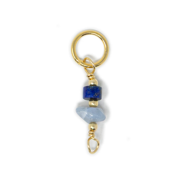 Lapis and blue opal stone charm shown on white
