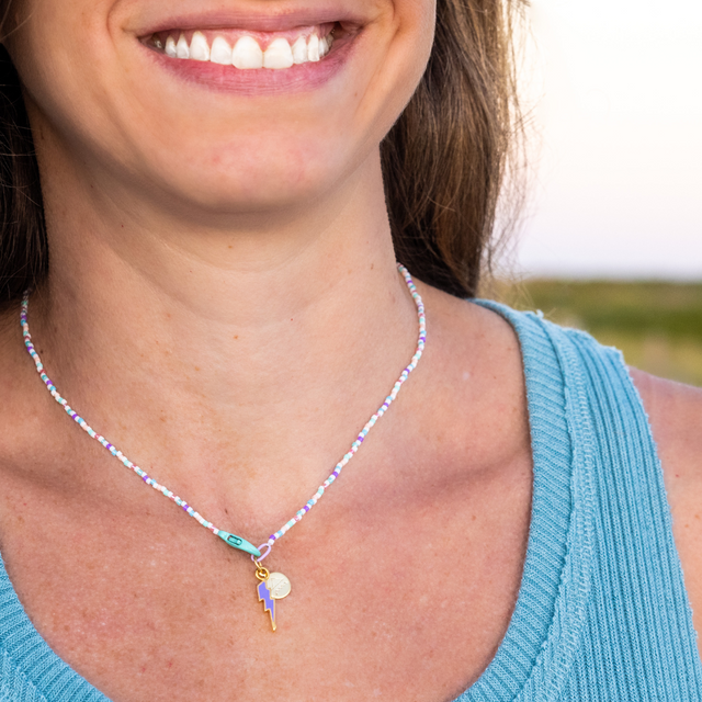 Lightening Clasp in Front Charm Necklace on Model at the beach