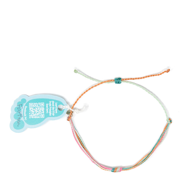 Colorful pink coral and teal knot anklet with Nica Life branded foot shaped tag shown on white