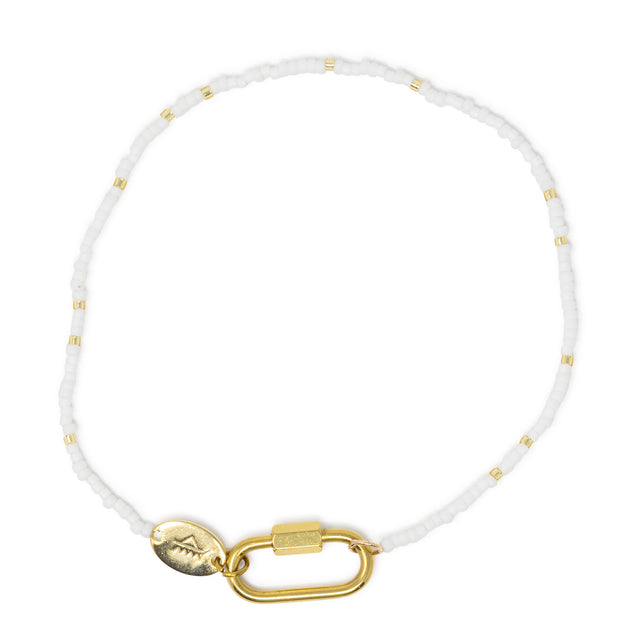 White & gold beaded charm bar anklet with carabiner clasp for charms shown on white.