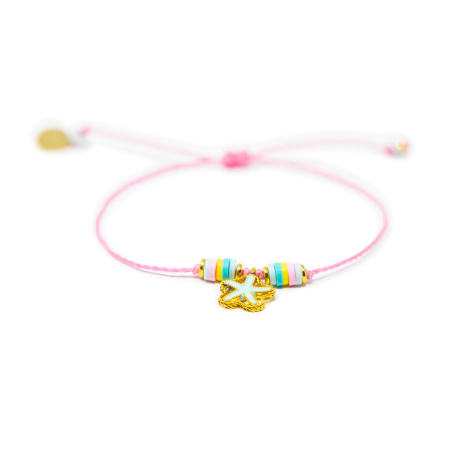 Pink string bracelet with colorful beads and a mint color starfish charm shown on white from the front