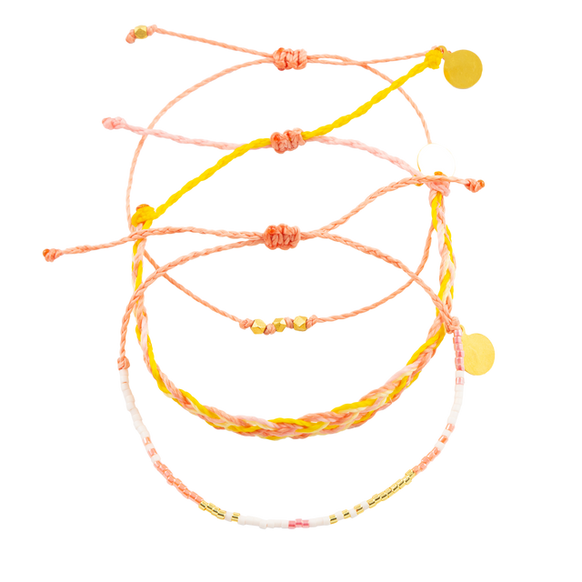 Three Pink Coral Yellow and Gold Bracelets on white shown from the top