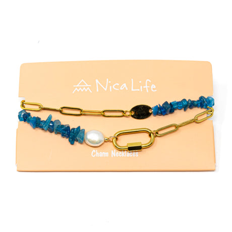 Charm necklace made with apatite beads, a pearl, and gold chain with a carabiner clasp on a 'Nica Life' branded card with a white background