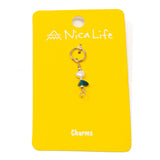 Apatite and pearl charm for charm necklace or bracelet shown on golden yellow Nica Life branded card