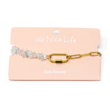 Charm bracelet with aquamarine crystal and gold chain design on a Nica Life branded card