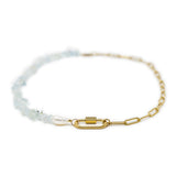 Charm necklace with gold chain and aquamarine beads with a carabiner clasp on white