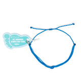Bright blue teal string knot anklet with a Nica Life branded foot shaped tag shown on white