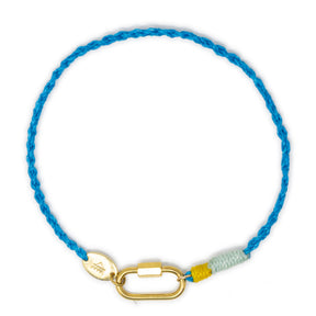 Blue braided cord anklet with a gold carabiner clasp for charms on a white background