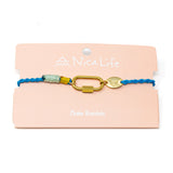 Cord charm bracelet with gold  carabiner clasp for charms on a pink card with 'Nica Life' branding