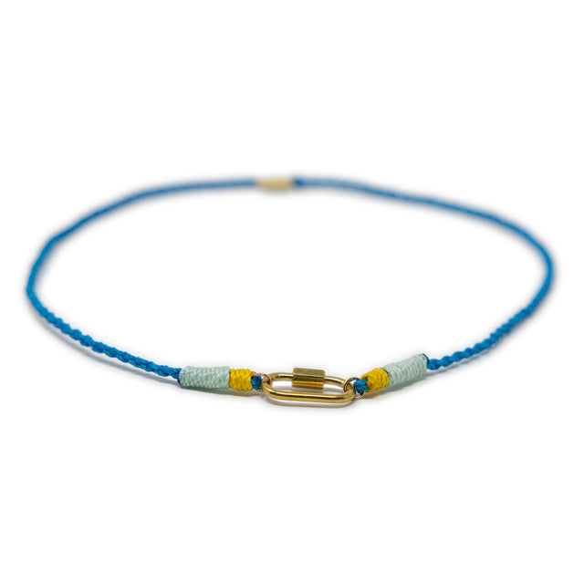 Hand made blue cord bracelet with a gold carabiner clasp for charms on a white background