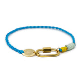 Charm gracelet with blue cord, gold carabiner clasp, and colorful accents on a white background