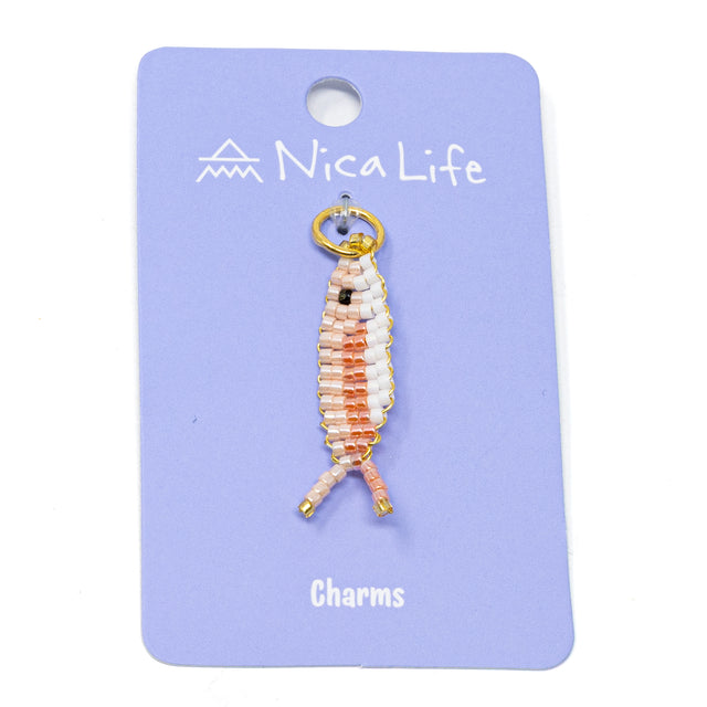 Handmade two tone pink fish charm for a charm bracelet or necklace on purple Nica Life branded card 
