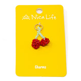 Beaded cherry charm on a yellow card with 'Nica Life' branding