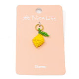 Hand beaded lemon charm on pink Nica Life branding card