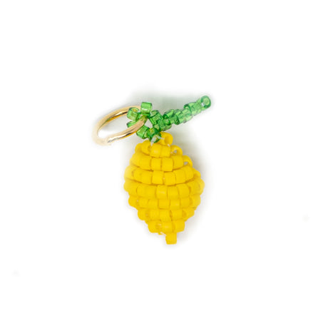 Hand beaded lemon charm for charm necklace or bracelet shown on white