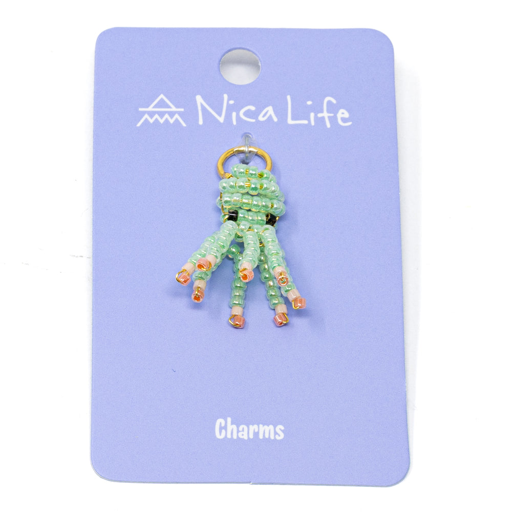 Hand beaded mint & coral octopus charm for charm bracelet or necklace on purple Nica Life branded card