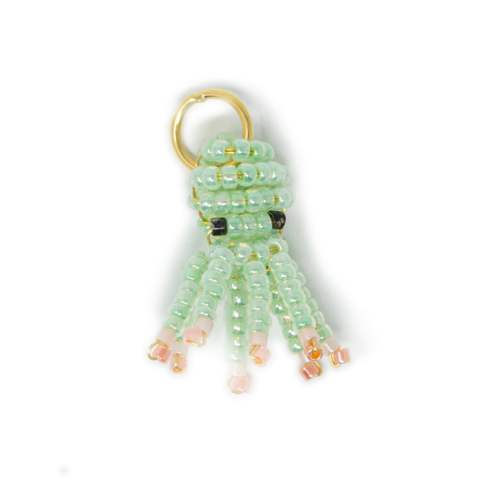 Mint & coral hand beaded octopus charm for charm necklace or bracelet shown on white