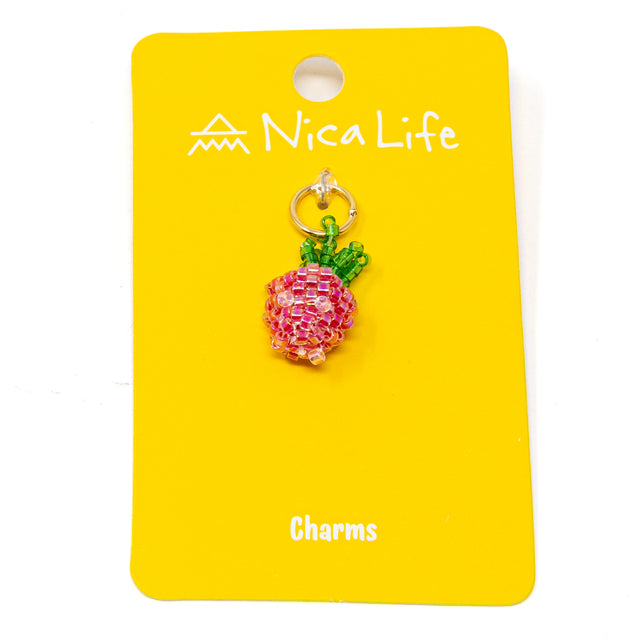Hand beaded strawberry charm on a yellow card with 'Nica Life' branding