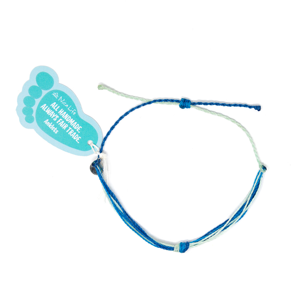 Teal multicolor string knot bracelet with Nica Life branded foot shaped tag shown on white