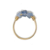 Three blue opal stones on a gold ring shown on white top view