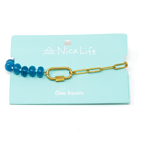 Bracelet with blue beads and gold chain and a gold carabiner for charms on a teal Nica Life branded card