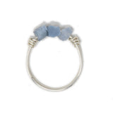 Three blue opal stones on silver ring shown on white