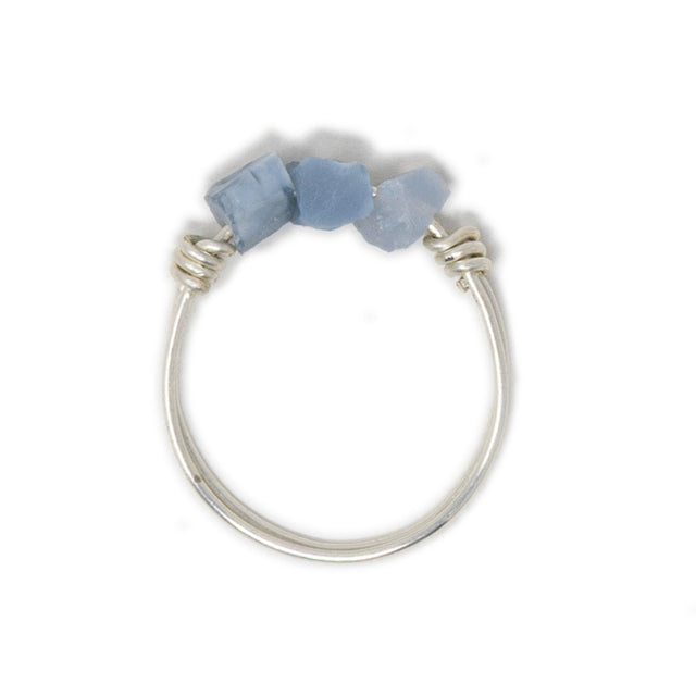 Three blue opal stones on silver ring shown on white