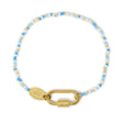 Charm bar bracelet with blue and gold beads and a gold carabiner clasp for charms on a white background