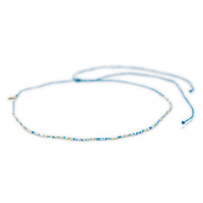 Blues and gold beaded choker with adjustable waterproof clasp shown on white from front 