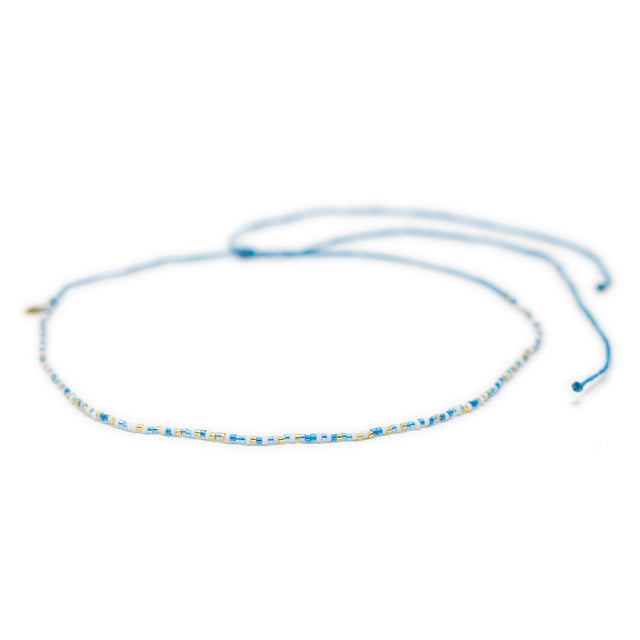 Blues and gold beaded choker with adjustable waterproof clasp shown on white from front 