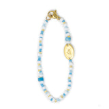 Blue multicolor hand beaded bag charm shown on white 
