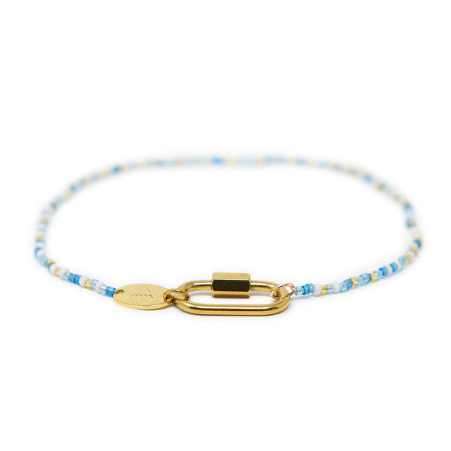 Blues & gold charm bar anklet with carabiner clasp for charms shown on white front view.
