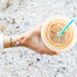 Clover & Teal Popoyo On Model holding coffee at the beach