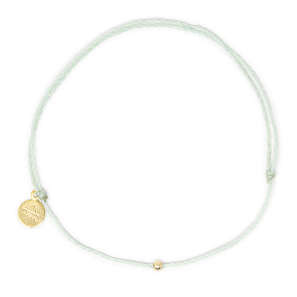 Cucumber mint color thread anklet with gold filled bead on white top view