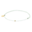 Cucumber mint color thread anklet with a gold filled bead on white front view