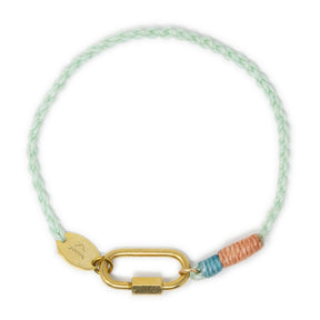 Bracelet with gold carabiner clasp for charms handmade with colorful cord on a white background