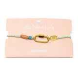 Charm bracelet with gold carabiner clasp made with colorful cord on a Nica Life branded card