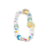 Bright colorful hand beaded bag charm on a white background