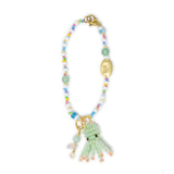 Beaded bag charm with a green octopus charm on a white background