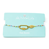 Bright mulit color charm bar bracelet with gold carabiner clasps for charms on a teal Nica Life branded card.
