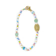 Hand beaded bag charm with colorful beads and a gold clasp on a white background