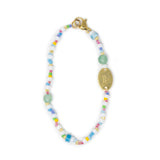 Hand beaded bag charm with colorful beads and a gold clasp on a white background