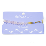 Gold charin & pink stone anklet shown on a purple Nica Life branded card