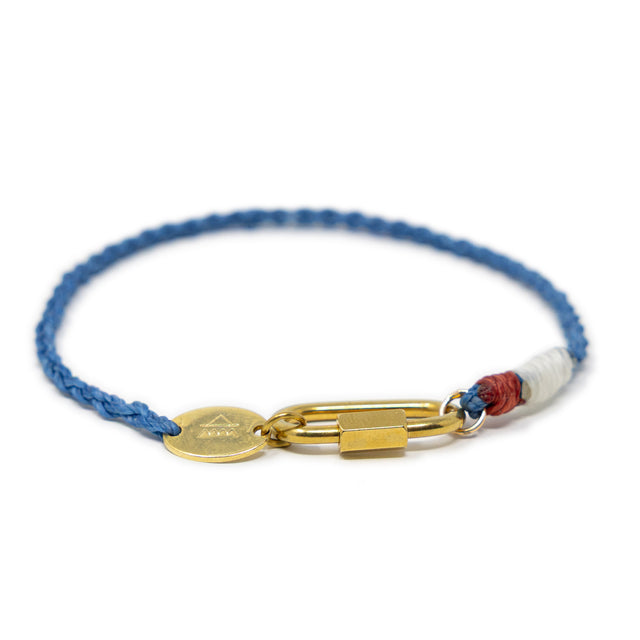 Blue hand braided cord bracelet with gold carabiner clasp for charms and red and white accents on a white background