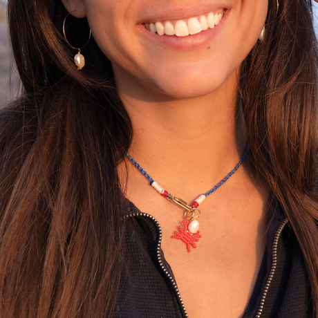 Model wearing a nautical colored rope necklace with beaded crab charm & pearl charm 